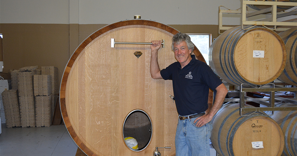 Chris Loxton with wine barrels